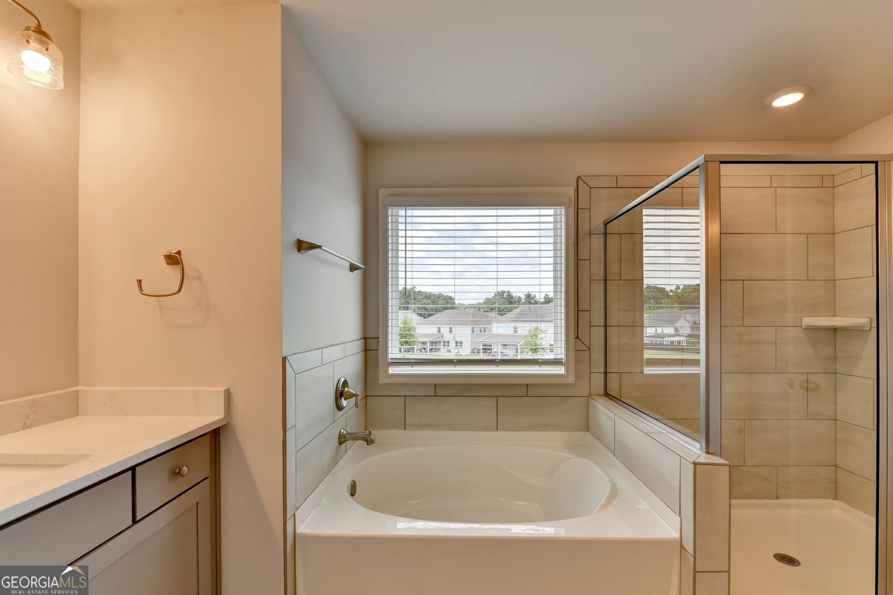 Bathroom with separate tub and glass enclosed shower