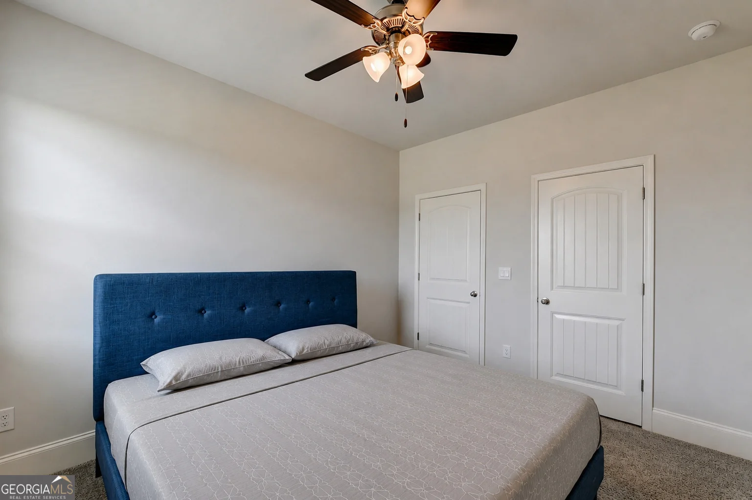 Additional bedroom with window and ceiling fan